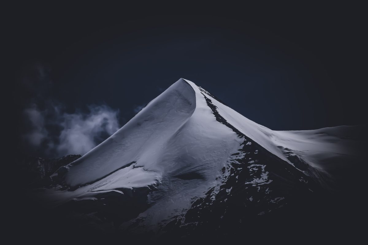 grayscale photo of mountain covered with snow
